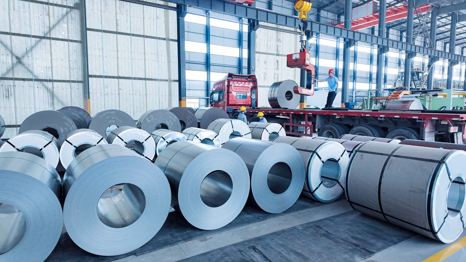Steel coils being loaded onto a truck inside the Huiding Steel facility